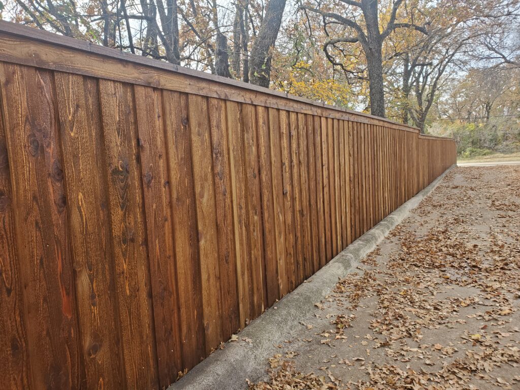 A wooden fence with no leaves on it