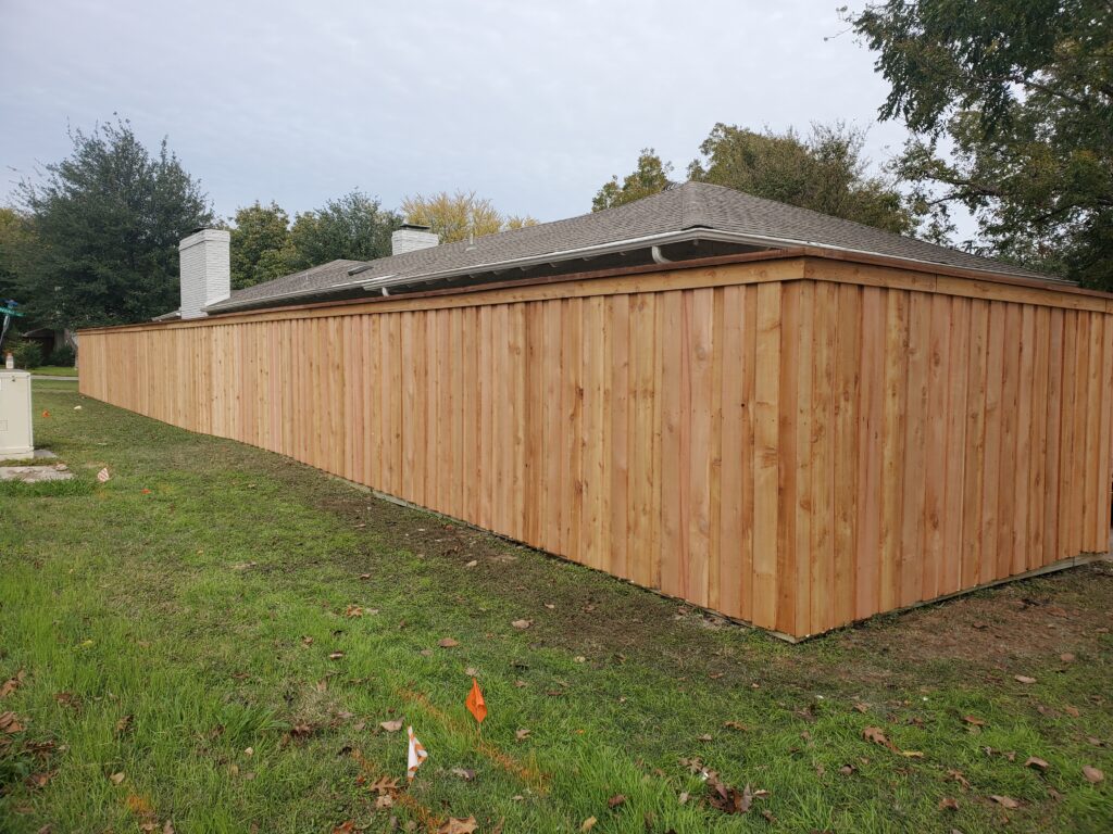 A wooden fence with a roof on top of it.